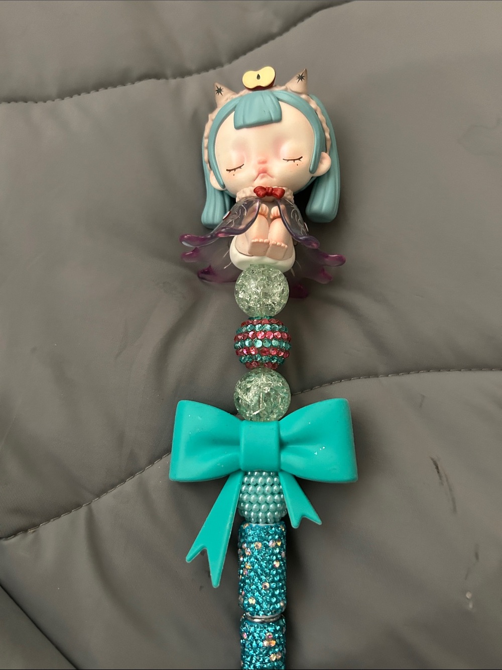 Teal Bow Beaded Pen with Sleeping Doll figurine